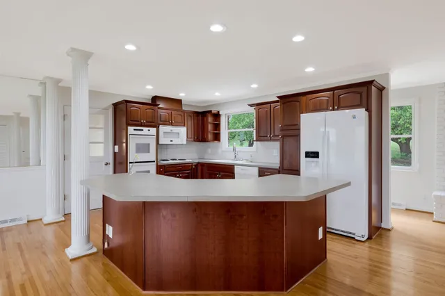 a kitchen with stainless steel appliances granite countertop a refrigerator a sink and a stove