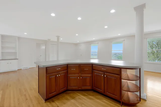 a kitchen with stainless steel appliances granite countertop a sink and cabinets with wooden floor