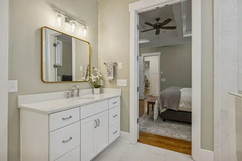 a bedroom with a bed and painting on the wall