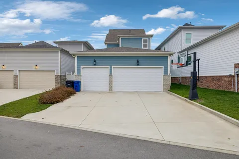 an aerial view of residential houses with outdoor space and lake view
