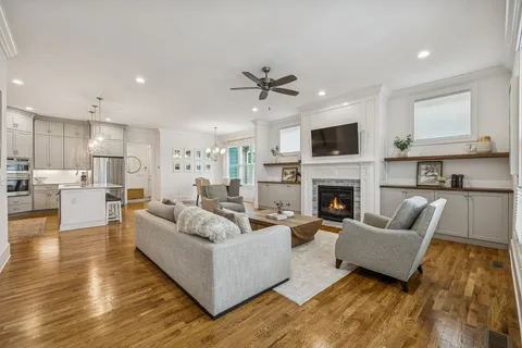 a living room with furniture fireplace and flat screen tv