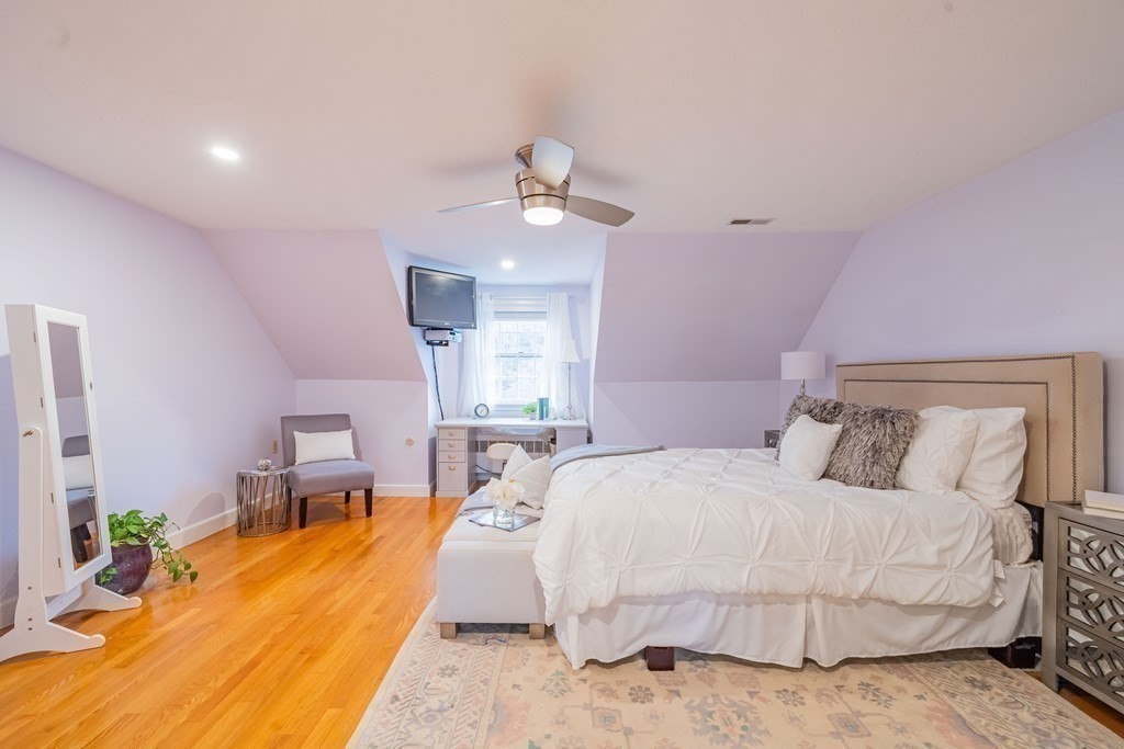 51 Robinson Road Lexington, MA 02420 - Photo 26 of 42 a bedroom with a bed chandelier chandelier and a window