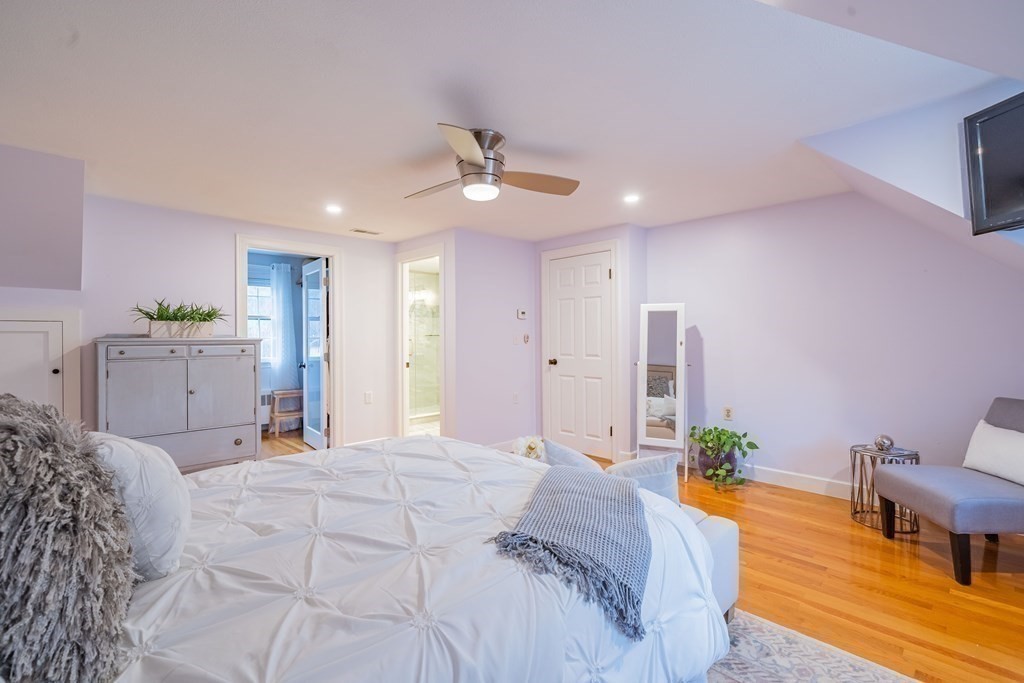 51 Robinson Road Lexington, MA 02420 - Photo 27 of 42 a bedroom with a bed and a chandelier