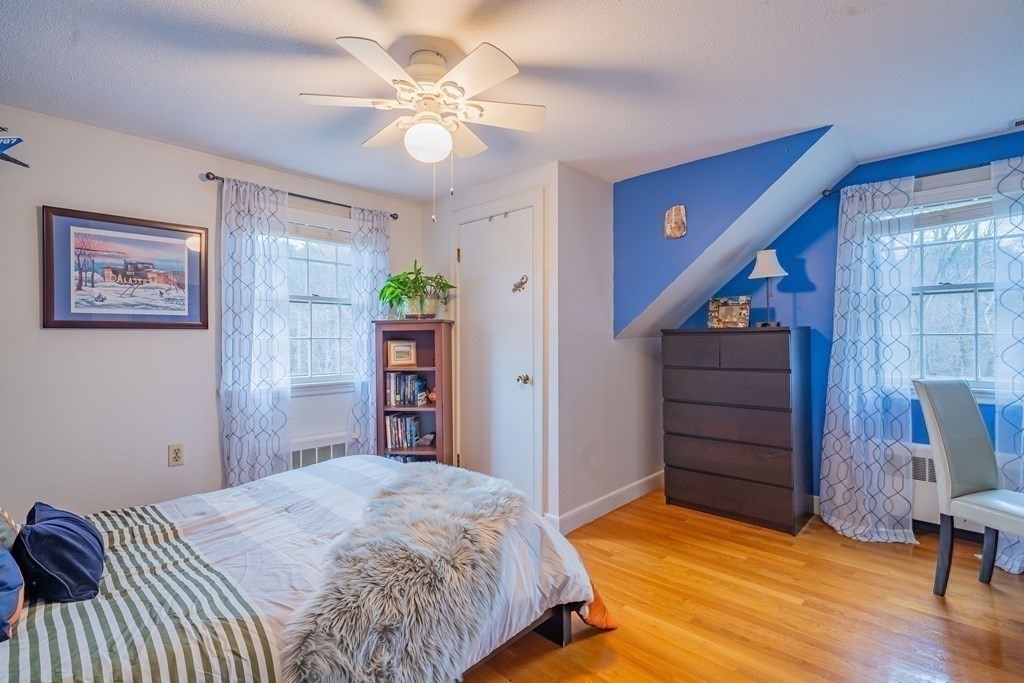 51 Robinson Road Lexington, MA 02420 - Photo 30 of 42 a bedroom with a bed and a chandelier