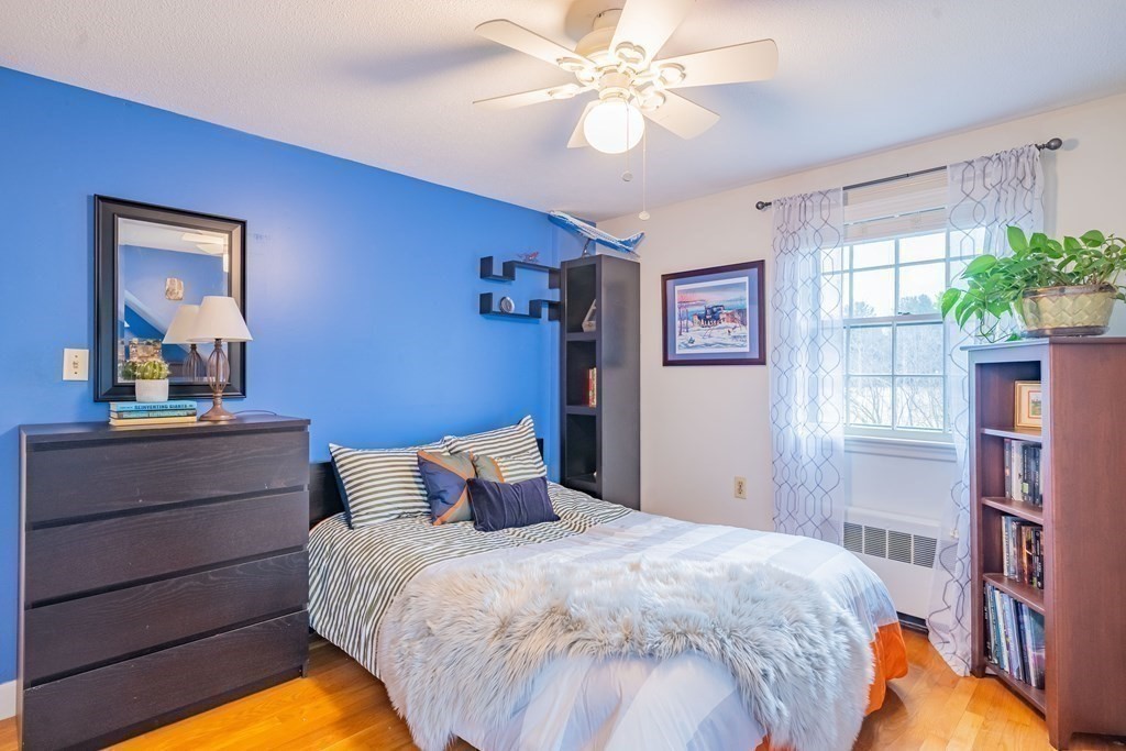 51 Robinson Road Lexington, MA 02420 - Photo 31 of 42 a bedroom with a bed and a chandelier