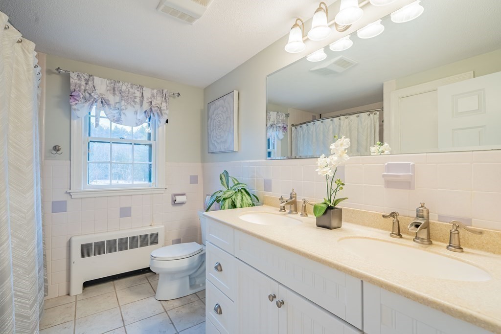 51 Robinson Road Lexington, MA 02420 - Photo 34 of 42 a bathroom with a granite countertop toilet sink and mirror