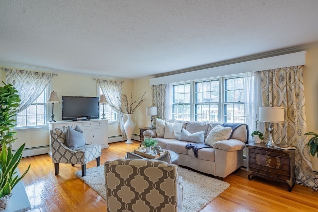 51 Robinson Road Lexington, MA 02420 - Photo 5 of 42 a living room with furniture a flat screen tv and a large window