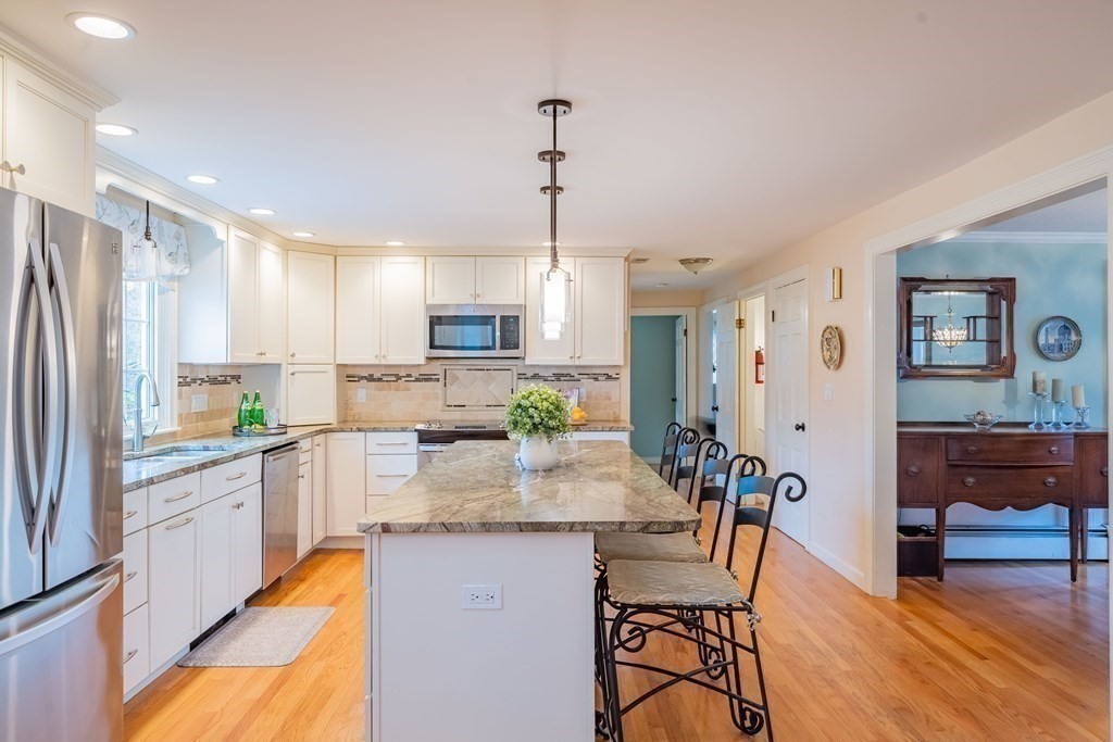 51 Robinson Road Lexington, MA 02420 - Photo 8 of 42 a kitchen with refrigerator cabinets dining table and chairs