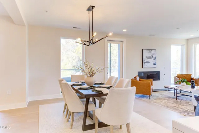 a dining room with furniture a chandelier and window