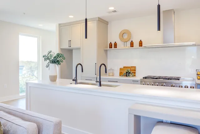 a view of a balcony with chairs and wooden floor