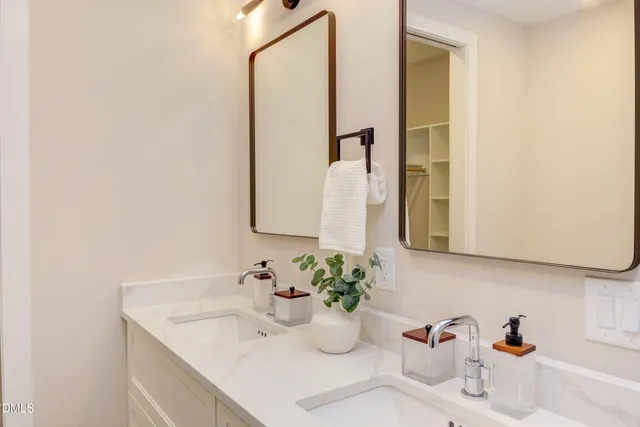 a en suite bathroom with a granite countertop sink and a mirror