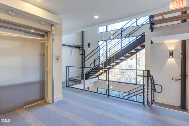 a large kitchen with kitchen island a large counter top space a sink stainless steel appliances and cabinets