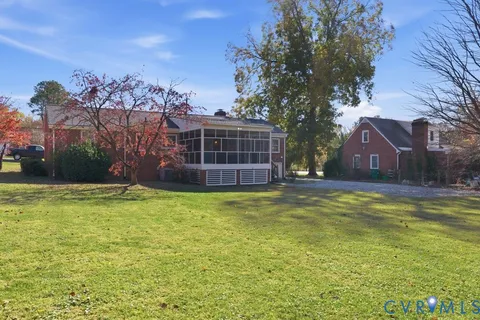 a view of a house with pool and a yard