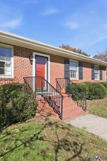 a view of a house with a small yard and plants