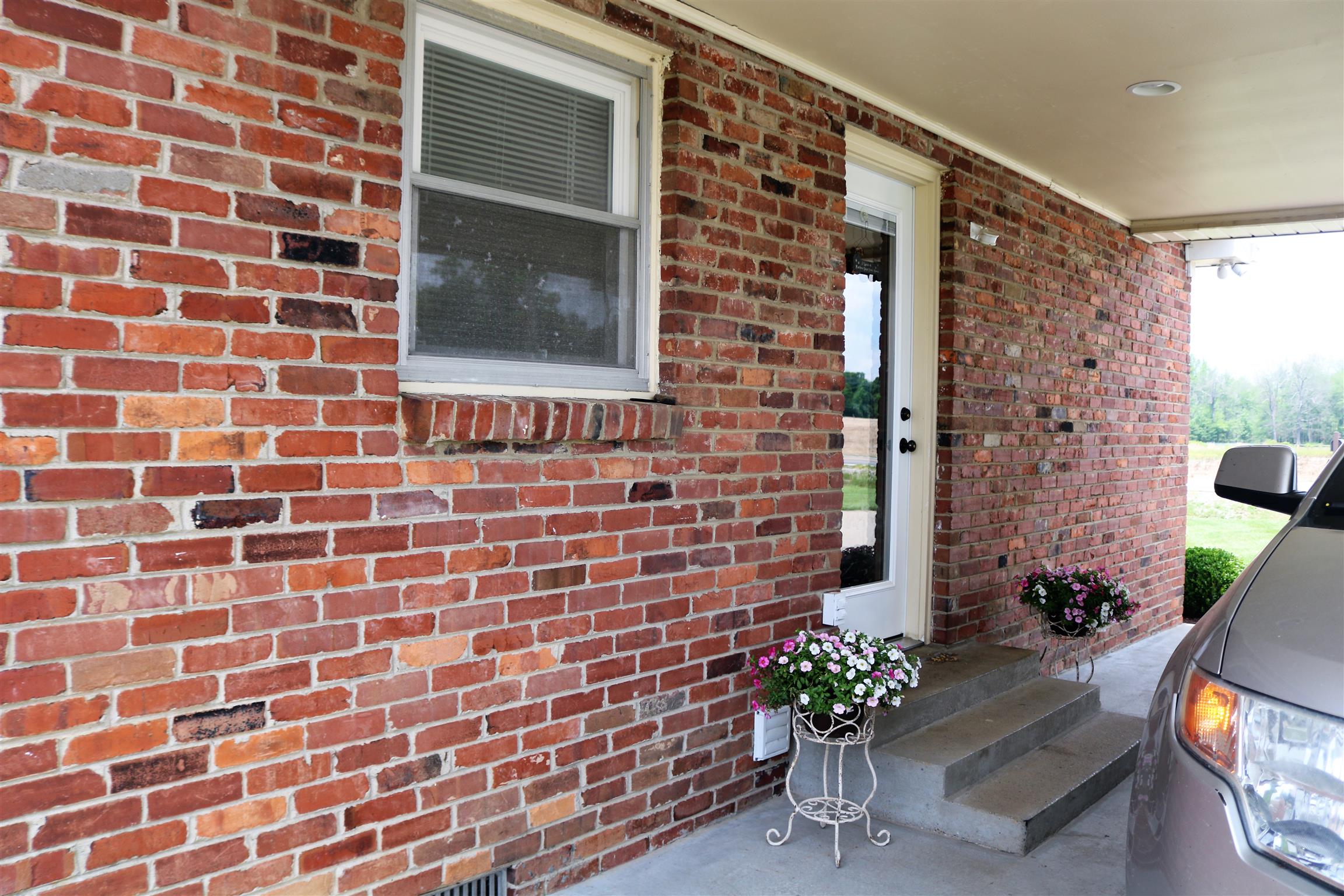 5937 Lakeview Road Springfield, TN 37172 - Photo 6 of 26 a brick building with a potted plant on a bench