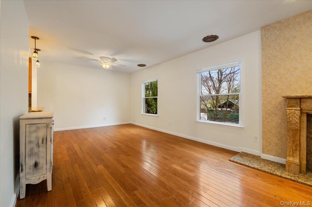 33 Fleets Cove Road Huntington, NY 11743 - Photo 18 of 42 Unfurnished living room with light wood-style flooring and a ceiling fan
