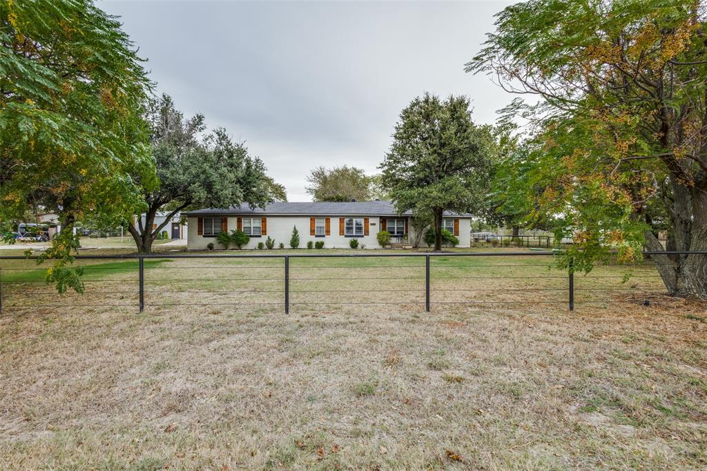 1200 Tipps Road Cross Roads, TX 76227 - Photo 2 of 32 a house with trees in the background