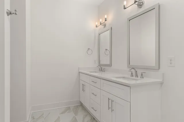 a bathroom with a double vanity sink and a mirror
