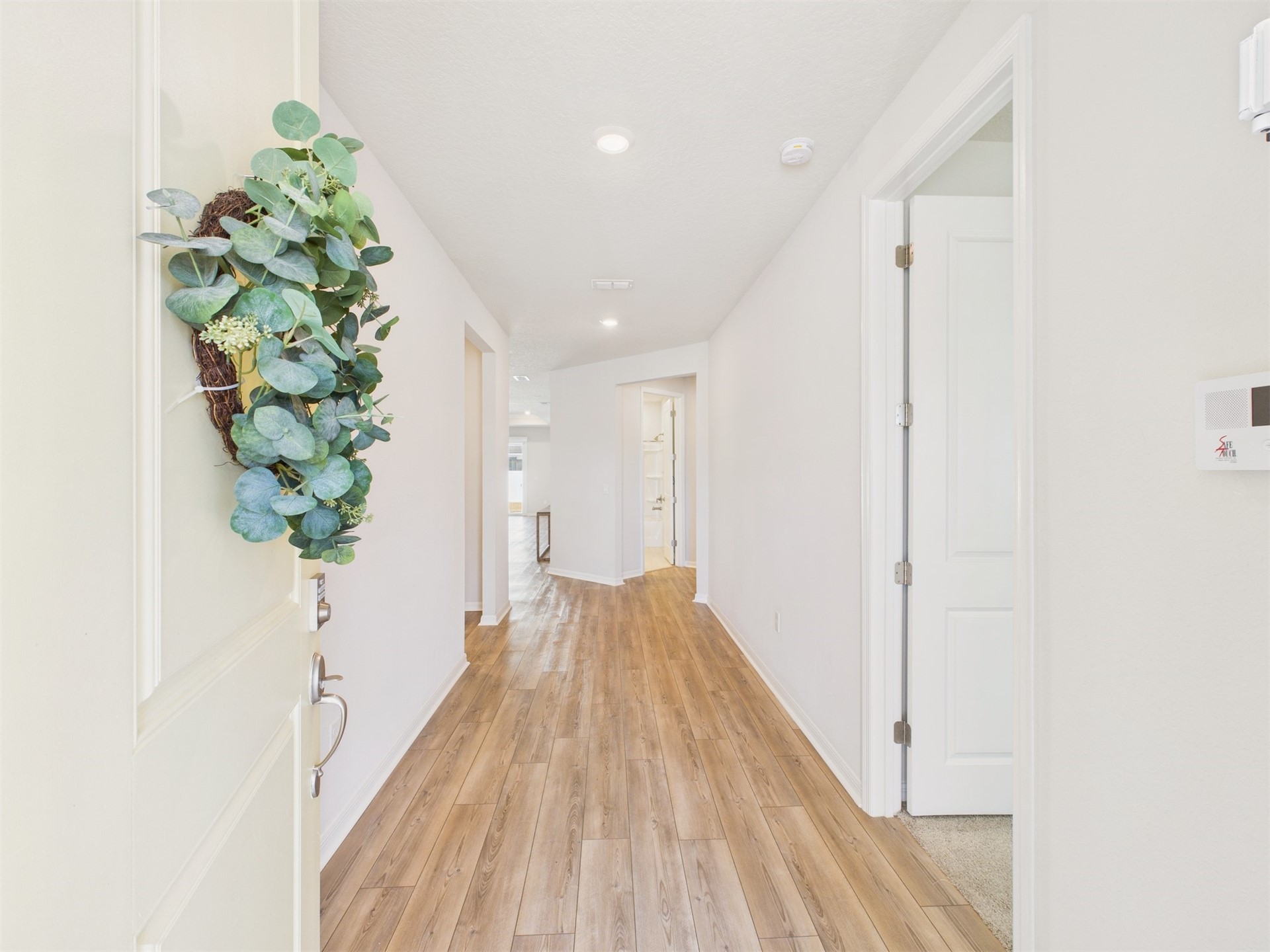 312 Salt Meadow Loop Yulee, FL 32097 - Photo 4 of 22 a view of a hallway with wooden floor and a potted plant
