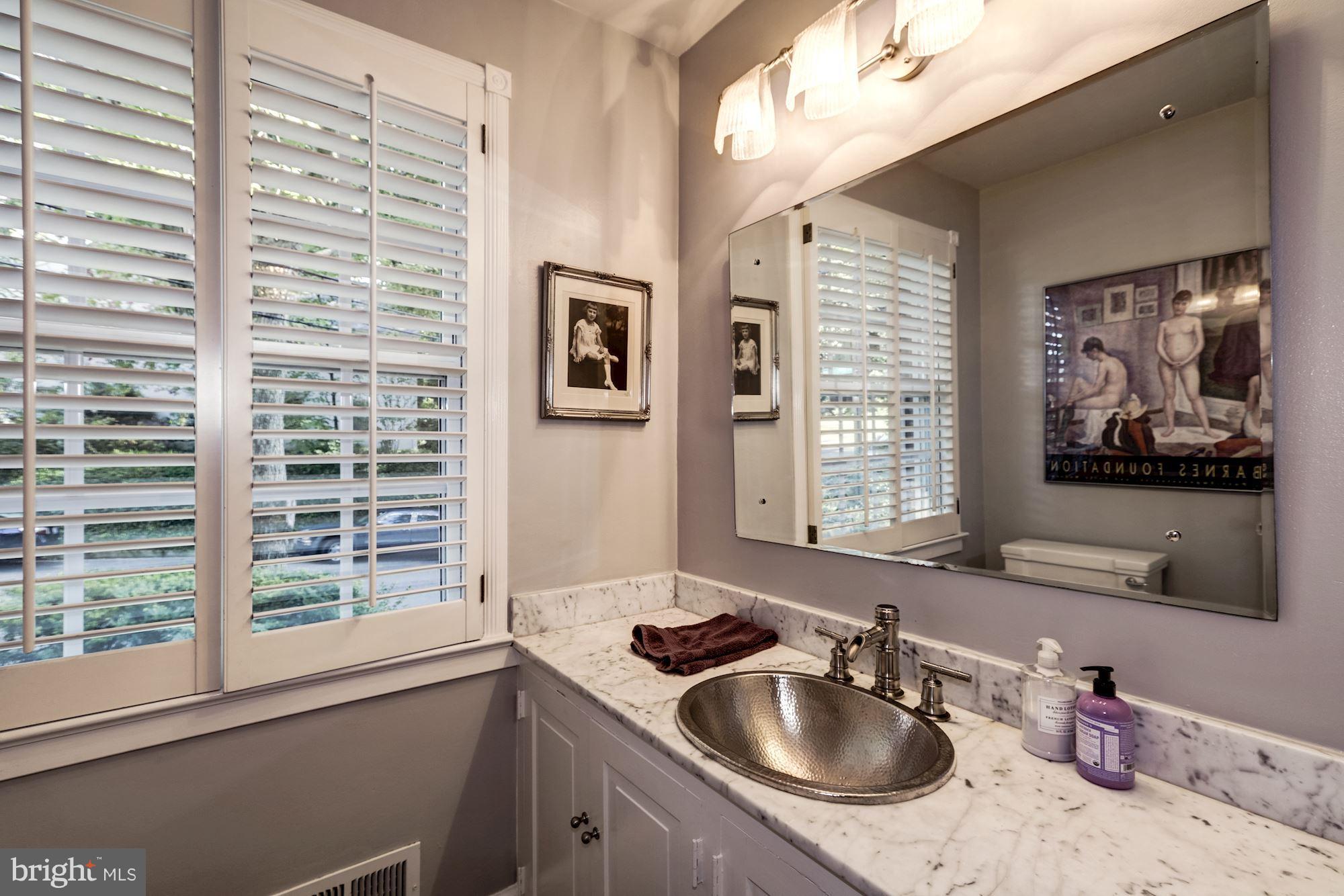 4767 Berkeley Terrace Northwest Washington, DC 20007 - Photo 14 of 30 a bathroom with a sink a window and a mirror