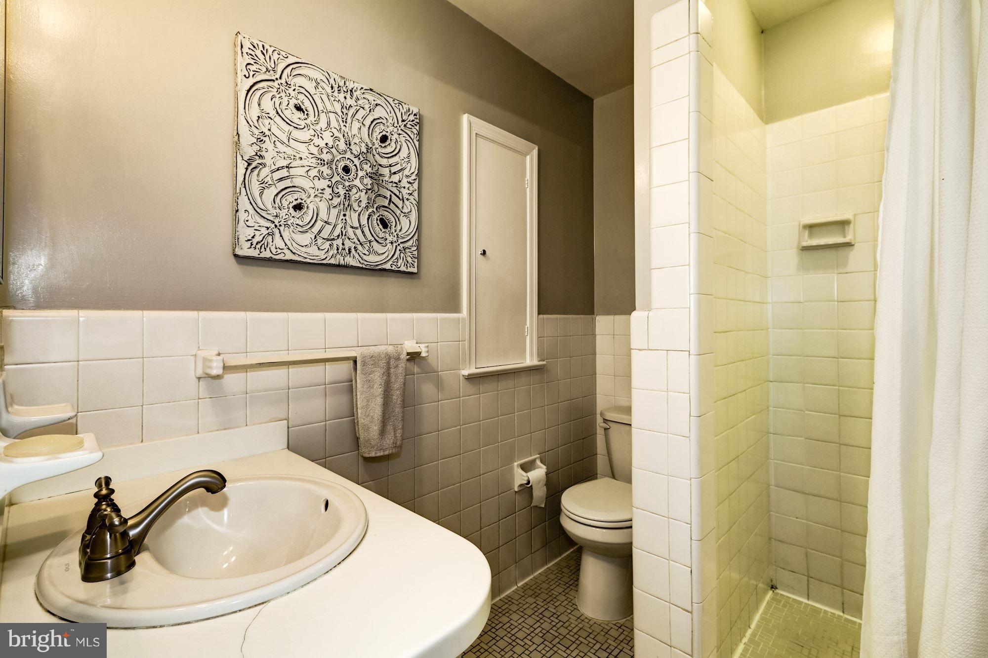4767 Berkeley Terrace Northwest Washington, DC 20007 - Photo 19 of 30 a bathroom with a toilet sink and mirror