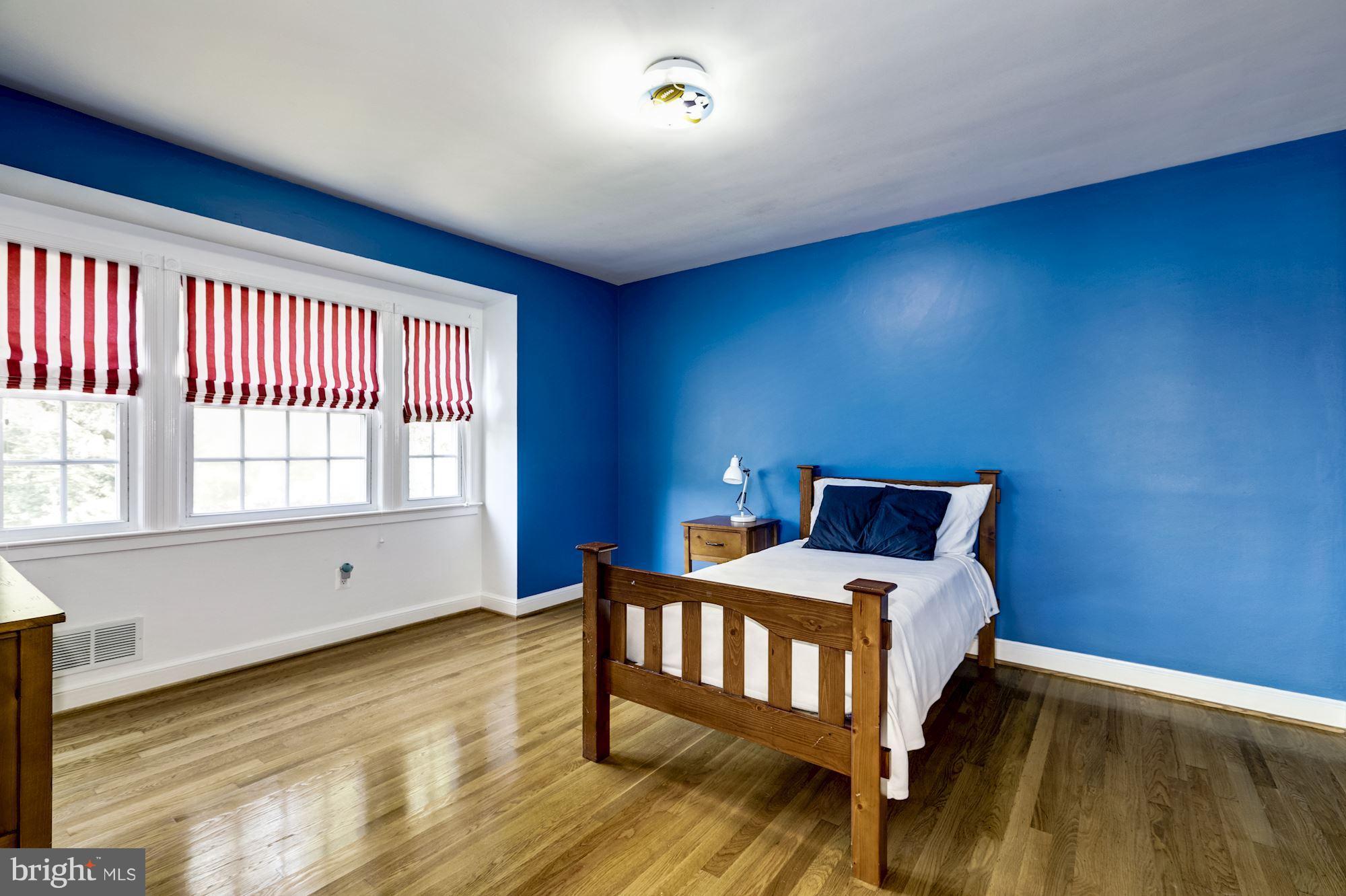 4767 Berkeley Terrace Northwest Washington, DC 20007 - Photo 22 of 30 a bedroom with a bed and wooden floor