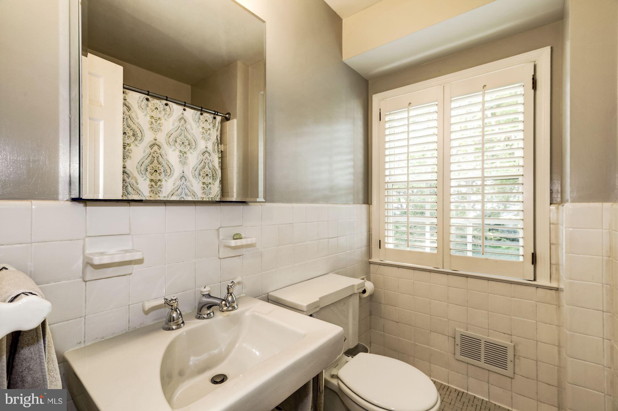4767 Berkeley Terrace Northwest Washington, DC 20007 - Photo 23 of 30 a bathroom with a sink and a mirror