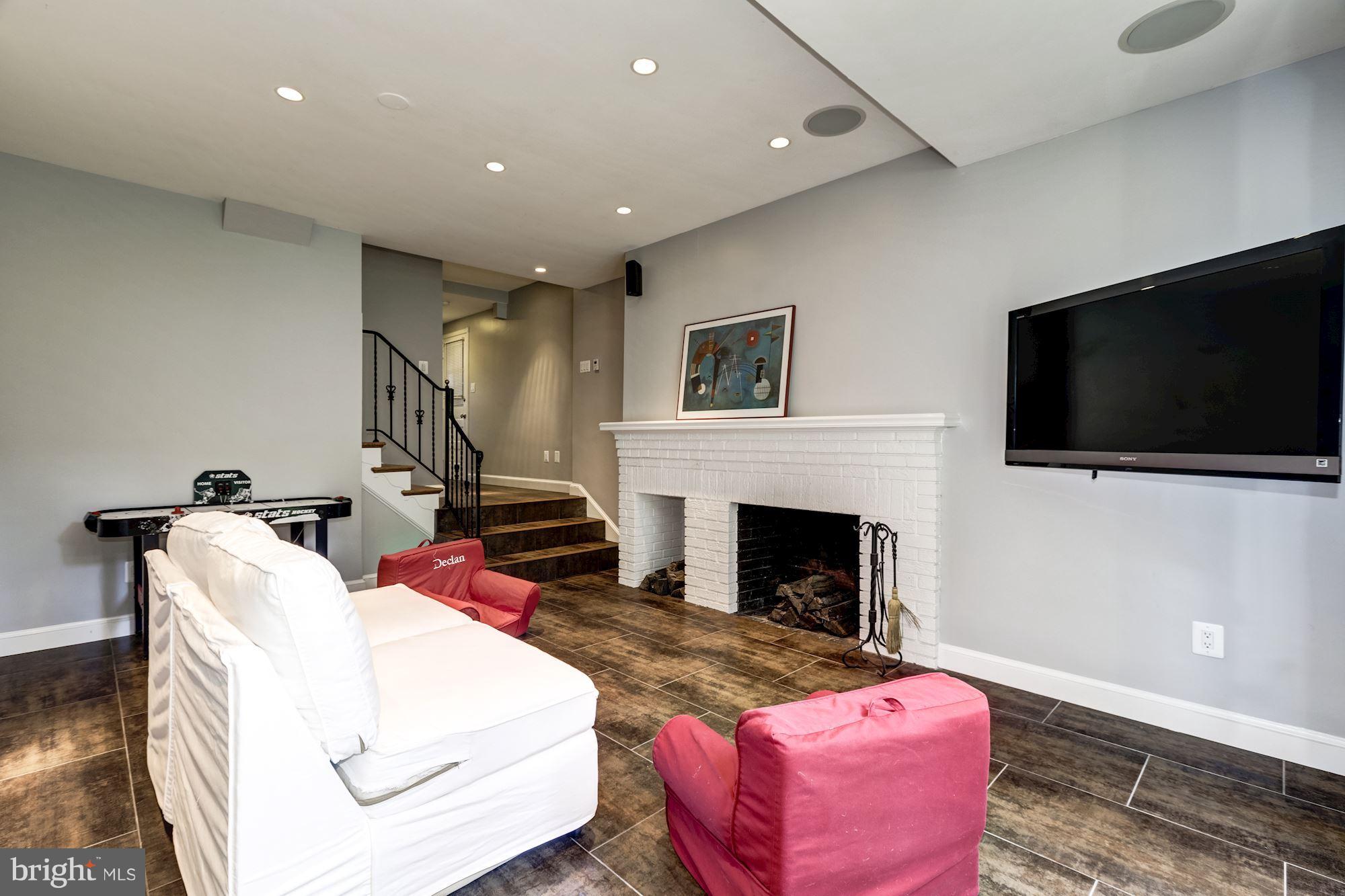 4767 Berkeley Terrace Northwest Washington, DC 20007 - Photo 25 of 30 a living room with furniture a flat screen tv and a fireplace
