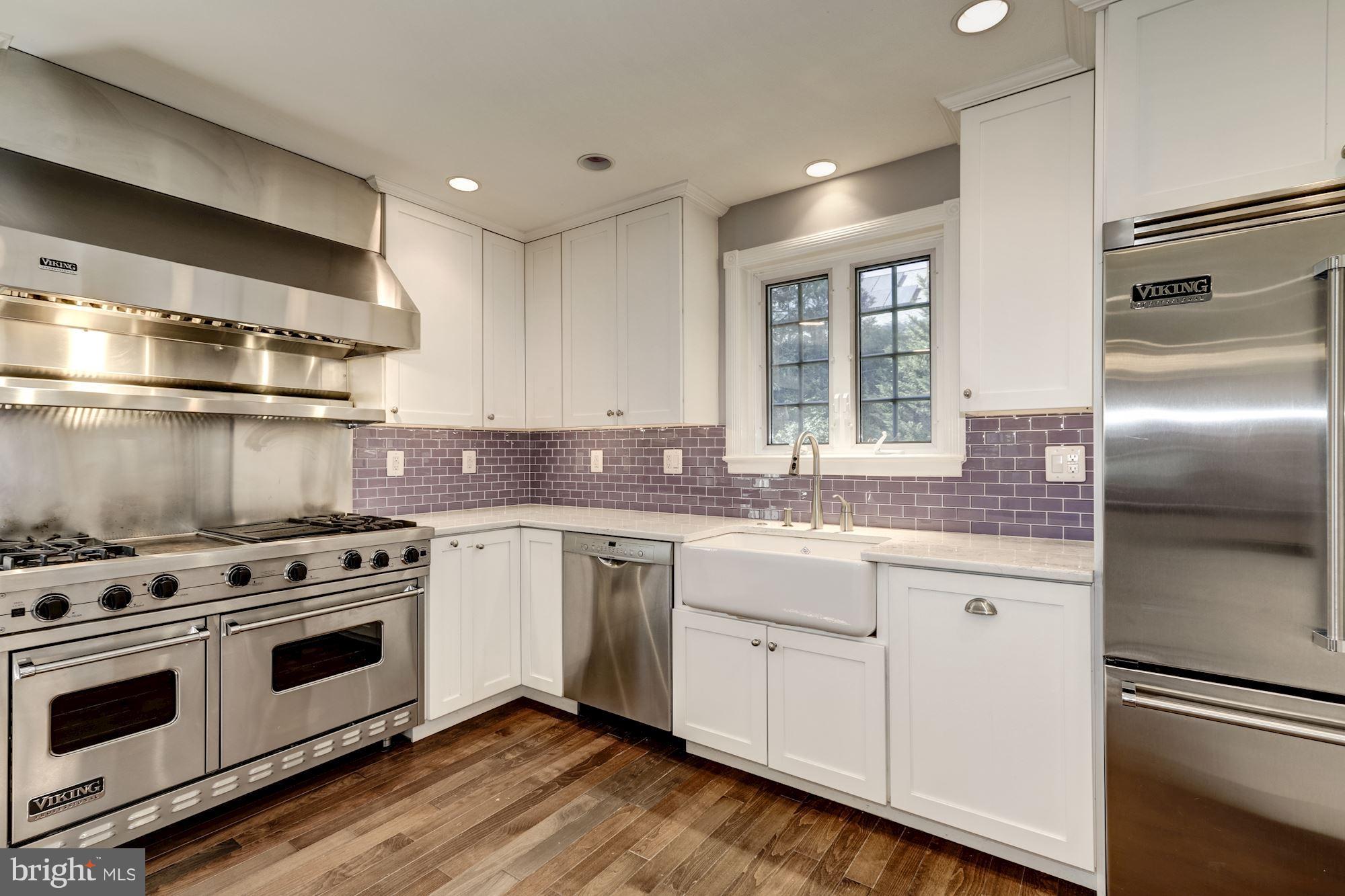 4767 Berkeley Terrace Northwest Washington, DC 20007 - Photo 8 of 30 a kitchen with stainless steel appliances granite countertop a stove a sink and a refrigerator