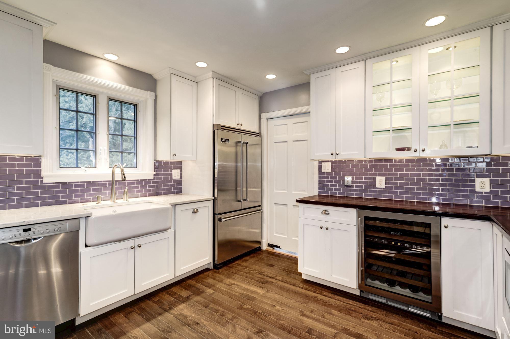 4767 Berkeley Terrace Northwest Washington, DC 20007 - Photo 10 of 30 a kitchen with stainless steel appliances granite countertop a sink stove and refrigerator