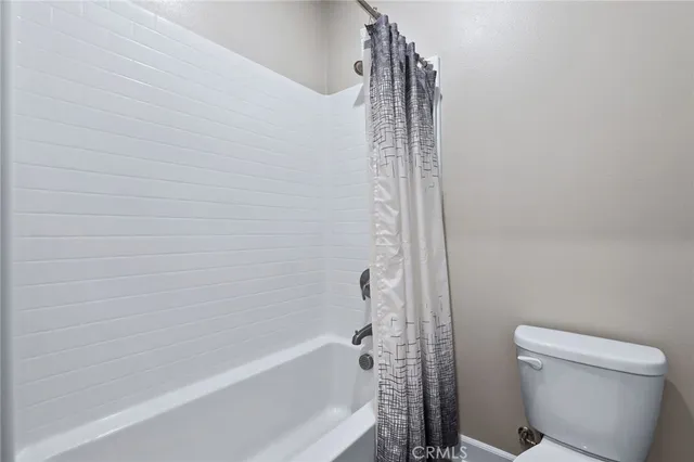 a bathroom with a bathtub and a toilet