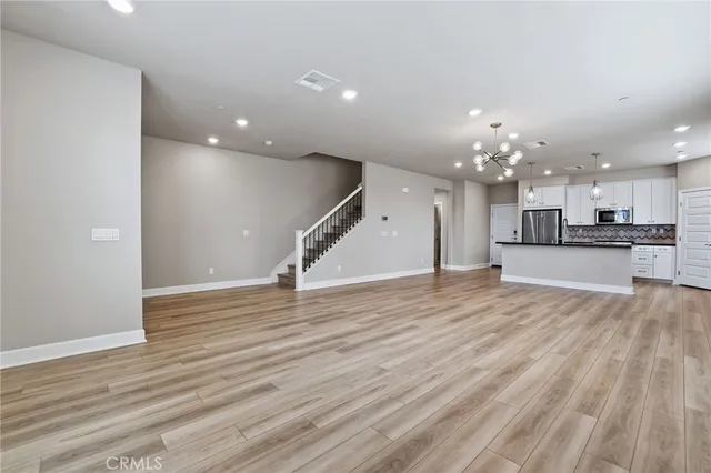 a view of a kitchen with a sink and wooden floor