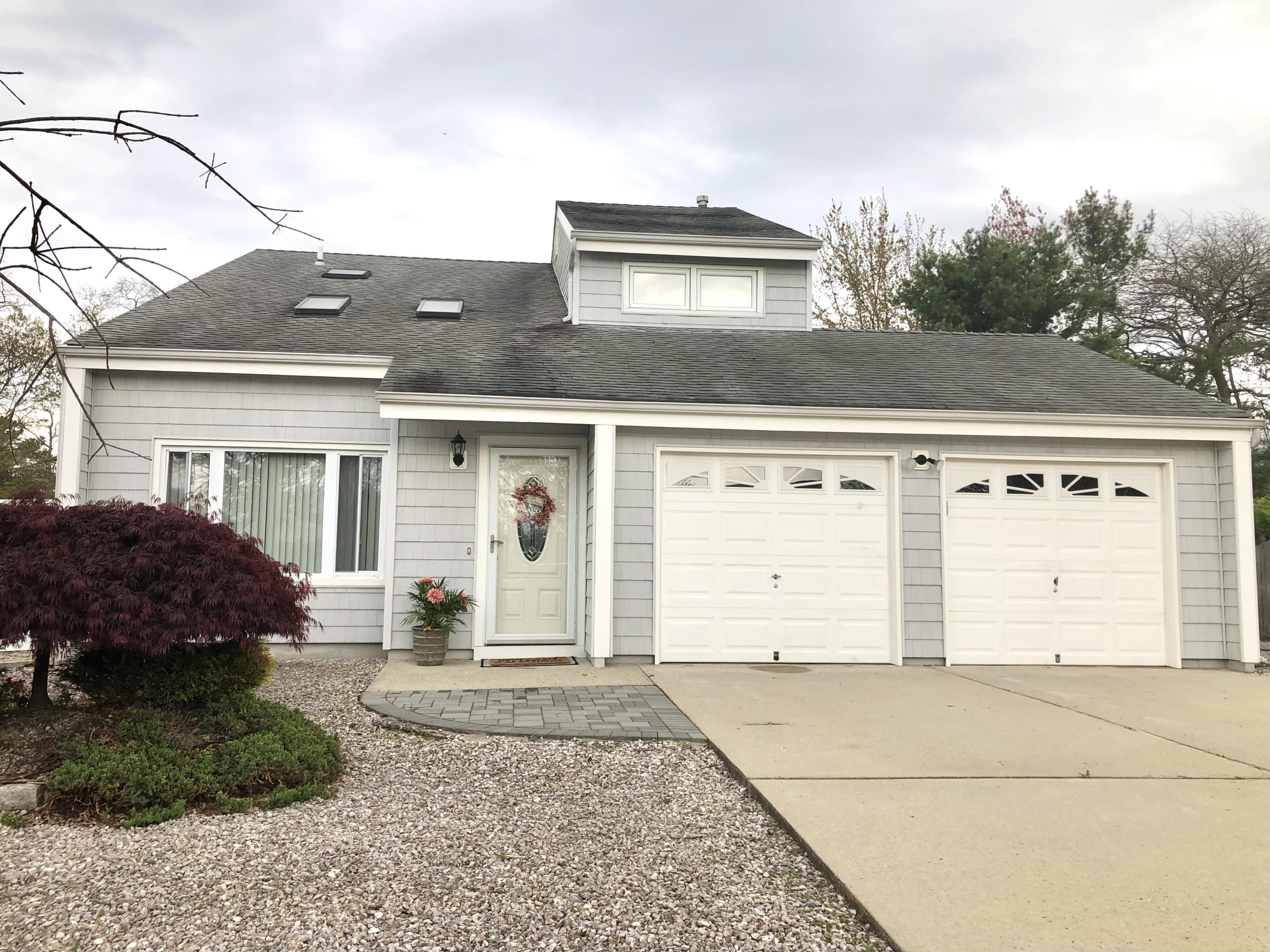 107 Reflection Road Toms River, NJ 08753 - Photo 1 of 29 a front view of a house with a yard and garage