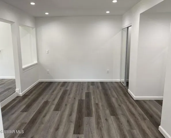 a view of wooden floor and windows in a room