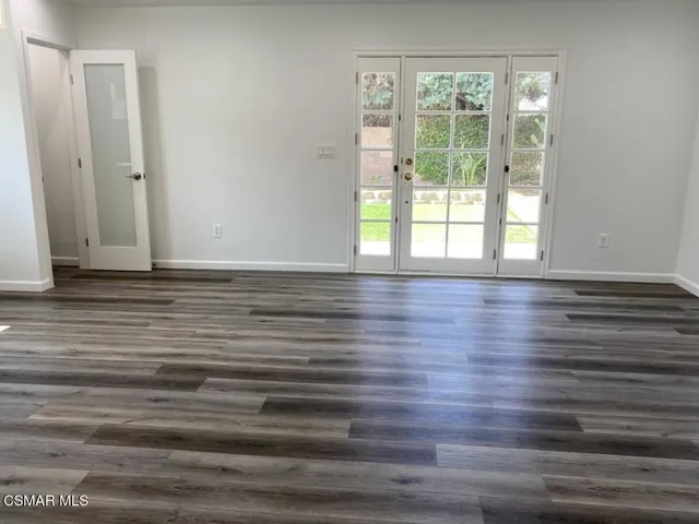 a view of wooden floor and windows in a room