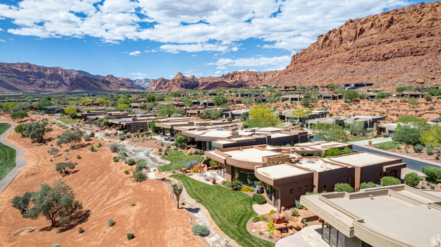 2331 West Entrada Trail, Unit 61 St. George, UT 84770 - Photo 68 of 69 Expansive desert landscape featuring a residential community with contemporary architecture, manicured green spaces, and a golf course