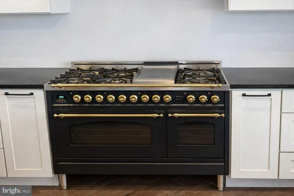 a living room with furniture and a dining table with wooden floor