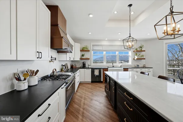 a living room with furniture a flat screen tv and kitchen area