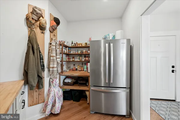 a front view of a house with a yard covered in snow
