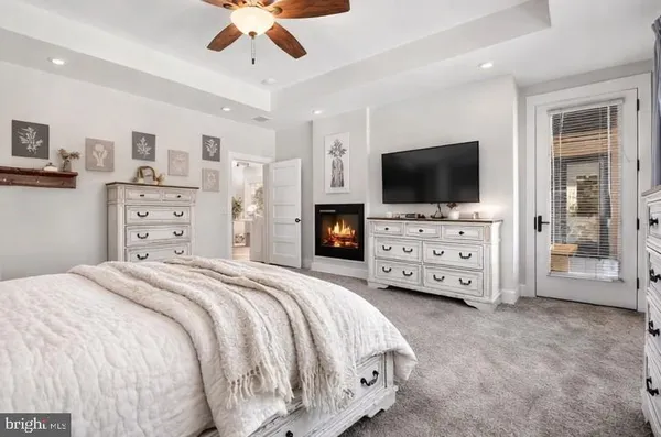a living room with furniture chandelier and a fireplace