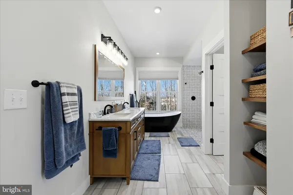 a bathroom with a granite countertop sink a toilet and shower