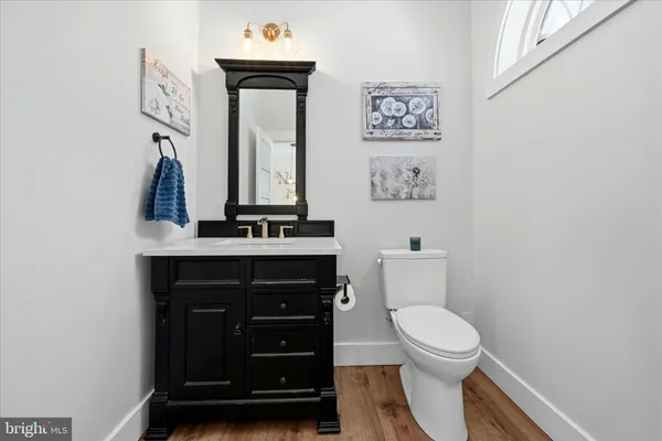 a front view of a house with a yard covered in snow