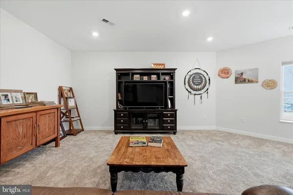a front view of a house with a yard and mountain view in back