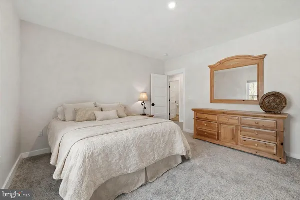 a dining room with wooden floor a chandelier a wooden table and chairs