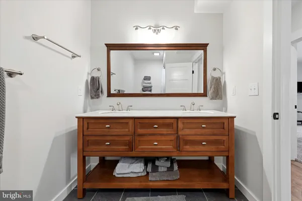 a dining room with wooden floor a chandelier a wooden table and chairs