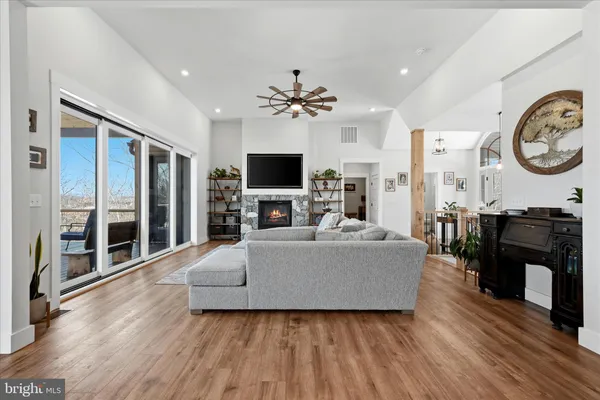 a kitchen with stainless steel appliances granite countertop a table chairs stove and white cabinets