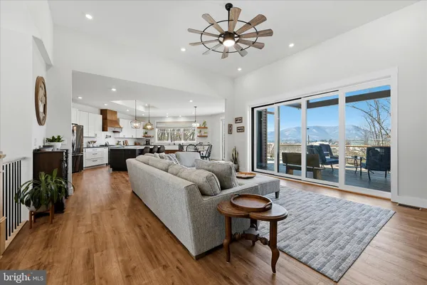 a kitchen with stainless steel appliances granite countertop a sink a stove and a wooden floors