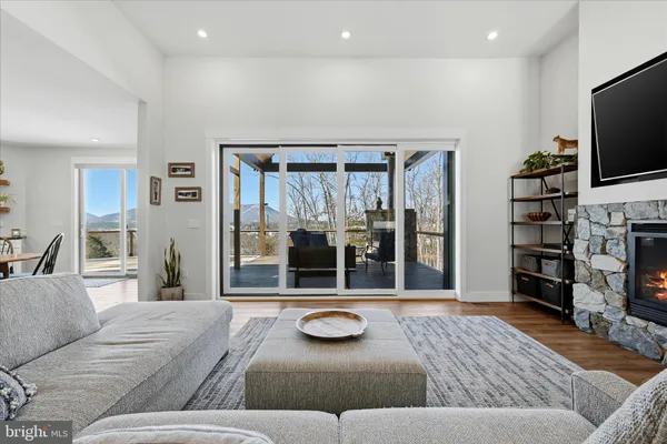 a kitchen with stainless steel appliances a refrigerator and a wooden floor