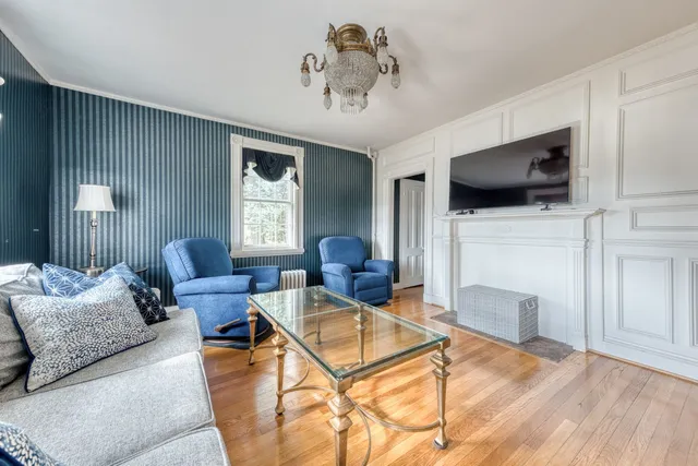 a living room with furniture and a chandelier