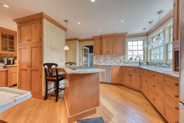 a spacious bathroom with a granite countertop sink mirror and a bathtub